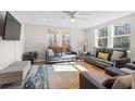 Bright living room featuring a ceiling fan, large windows, and comfortable seating area at 3595 South Nw St, Duluth, GA 30096