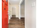 Inviting entryway featuring hardwood floors, a bright red front door, and neutral wall paint at 3995 Emerald North Dr, Decatur, GA 30035