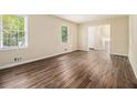 Bright living room with hardwood floors, and two large windows offering plenty of natural light at 3995 Emerald North Dr, Decatur, GA 30035