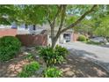 Landscaped townhouse with a garage and lovely front yard featuring a shade tree at 5058 Meadow Ne Ln, Marietta, GA 30068