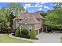 Stately home featuring an attached three-car garage and beautiful landscaping at 770 Pine Leaf Ct, Alpharetta, GA 30022