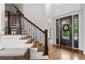 Elegant foyer featuring hardwood floors, staircase with iron railings, and front door with decorative glass at 2660 Pete Shaw Rd, Marietta, GA 30066