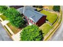 Aerial view of a brick home with a large backyard and mature trees at 417 Bell Flower Trl, Locust Grove, GA 30248
