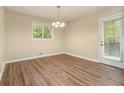 Inviting dining room featuring hardwood floors, a modern light fixture, and a door leading to the outside at 2724 Quincy Ln, Decatur, GA 30034