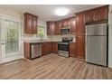 Well-equipped kitchen features stainless steel appliances, dark cabinets, and a door to the outside at 2724 Quincy Ln, Decatur, GA 30034