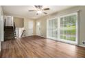 Bright living room with hardwood floors, ceiling fan, large windows offering serene views of the surrounding landscape at 2724 Quincy Ln, Decatur, GA 30034