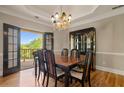 Elegant dining room with hardwood floors, french doors to the deck, and a chandelier at 3460 Highgate Hills Ne Dr, Duluth, GA 30097