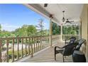 Relax on this porch, featuring ceiling fans and stunning views of the surrounding greenery at 3460 Highgate Hills Ne Dr, Duluth, GA 30097