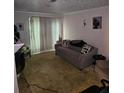Cozy living room with a comfortable sofa and neutral decor at 908 Pine Oak Trl, Austell, GA 30168
