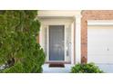 The front door is painted gray, and is framed by sidelights and white trim at 2324 Towneheights Se Ter # 11, Atlanta, GA 30339