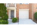 Lovely townhouse exterior featuring a brick facade, attached garage, and neat landscaping at 2324 Towneheights Se Ter # 11, Atlanta, GA 30339