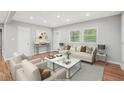 Bright living room features stylish furniture, hardwood floors, and lots of natural light from the windows at 2450 Elkhorn Dr, Decatur, GA 30034