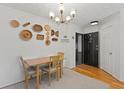 Dining room featuring a wooden table, a modern chandelier, and decorative wall art at 970 Sidney Marcus Ne Blvd # 2408, Atlanta, GA 30324
