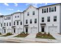 New townhomes with white siding, black shutters and doors, and manicured lawns at 3149 Washburn Sw St, Atlanta, GA 30354