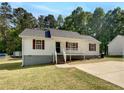 Quaint single-story home boasts white siding, red shutters, and a well-maintained front lawn at 45 Carroll St, Temple, GA 30179