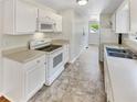 Functional kitchen featuring white cabinetry, modern appliances, and neutral countertops at 45 Carroll St, Temple, GA 30179