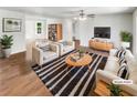 Bright and airy living room with neutral furniture, hardwood floors, and a cozy rug at 45 Carroll St, Temple, GA 30179