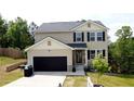Charming two-story home with a black garage door, neutral siding, and neatly landscaped front yard at 11 Plymouth Ct, Kingston, GA 30145