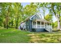 A charming home featuring a well-maintained lawn and mature trees at 1290 Campbellton Sw Rd, Atlanta, GA 30310