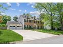 Charming brick home with dormer windows, attached two-car garage, and a beautifully landscaped front yard at 2724 Saddle Ridge Lake Dr, Marietta, GA 30062