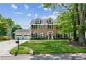 Beautiful two-story brick home with a well-maintained lawn, dormer windows, and a two-car garage at 2724 Saddle Ridge Lake Dr, Marietta, GA 30062