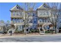 A row of charming two-story townhomes offers a blend of brick and siding exteriors at 702 Village Field Ct, Suwanee, GA 30024
