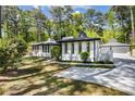 Attractive exterior view featuring a well-maintained yard and a private driveway leading to a detached garage at 888 Old Tucker Rd, Stone Mountain, GA 30087