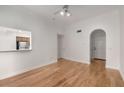 Open-concept living area with hardwood floors, white walls, and view to kitchen at 3777 Peachtree Ne Rd # 1536, Atlanta, GA 30319