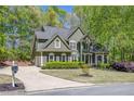 Charming two-story home with lush landscaping, a well-maintained lawn, and classic architectural details at 402 Glenhurst Trce, Canton, GA 30115