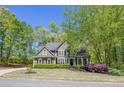 Charming two-story home with lush landscaping, a well-maintained lawn, and classic architectural details at 402 Glenhurst Trce, Canton, GA 30115