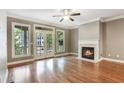 Cozy living room features hardwood floors, a fireplace, and access to a balcony at 737 St Charles Ne Ave, Atlanta, GA 30306