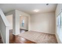 Open living room with hardwood floors and lots of natural light streaming through a large window at 115 Oakwood Dr, Covington, GA 30016
