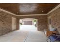 Covered carport area featuring a brick wall, doors, and a view of the garage with a glimpse of the yard at 401 Sara Ct, Loganville, GA 30052