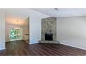 Inviting living room features a stone fireplace and stylish dark wood floors at 685 Greenhedge Dr, Stone Mountain, GA 30088