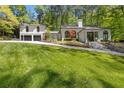 View of a beautiful home with lush green lawn and mature trees at 4067 Randall Farm Se Rd, Atlanta, GA 30339