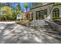 Elegant home entrance with stone steps, front door, and manicured landscaping at 4067 Randall Farm Se Rd, Atlanta, GA 30339
