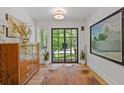Entryway featuring hardwood floors, stylish decor, and a glass panel front door at 4067 Randall Farm Se Rd, Atlanta, GA 30339