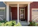 Covered entryway featuring brick pillars, a 'welcome' sign, and vibrant greenery at 1396 Dolcetto Nw Trce # 12, Kennesaw, GA 30152