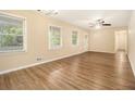 Bright living room features hardwood floors, multiple windows, and a ceiling fan for comfortable living at 3500 Finesse Dr, Decatur, GA 30032