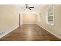 Spacious living room with hardwood floors, large windows for natural light, and a modern ceiling fan at 3500 Finesse Dr, Decatur, GA 30032