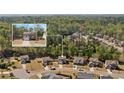 Aerial view of a residential area featuring well-spaced homes surrounded by lush greenery at 4150 Spring Ridge Dr, Cumming, GA 30028