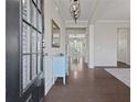Inviting foyer with hardwood floors and an elegant light fixture at 4150 Spring Ridge Dr, Cumming, GA 30028