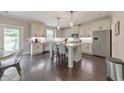 Modern kitchen with white cabinets, stainless steel appliances, an island, and hardwood floors at 1026 Towne Mill Xing, Canton, GA 30114