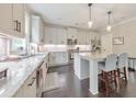 Bright kitchen with white cabinets, granite countertops, stainless appliances, and a kitchen island at 1026 Towne Mill Xing, Canton, GA 30114