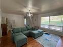 Living room with large windows, hardwood floors, and a plush blue sectional sofa adding comfort at 1379 Pair Sw Rd, Marietta, GA 30008
