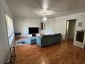 Bright living room with hardwood floors, a modern light fixture, and a comfortable blue sectional couch at 1379 Pair Sw Rd, Marietta, GA 30008