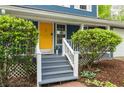 Close-up of the home's entrance featuring a striking yellow door and charming front porch at 2317 Danielle Ct, Marietta, GA 30062