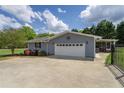 Attached garage with a concrete driveway, complemented by manicured landscaping and a gated entrance at 220 Pitts Chapel Rd, Newborn, GA 30056