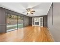 Elegant living room with hardwood floors, large sliding doors leading to the yard, and built-in shelving at 2667 Fieldstone Se Dr, Conyers, GA 30013