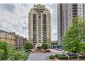 High-rise condo building showcasing manicured landscaping and covered parking at 799 Hammond Dr # 314, Atlanta, GA 30328